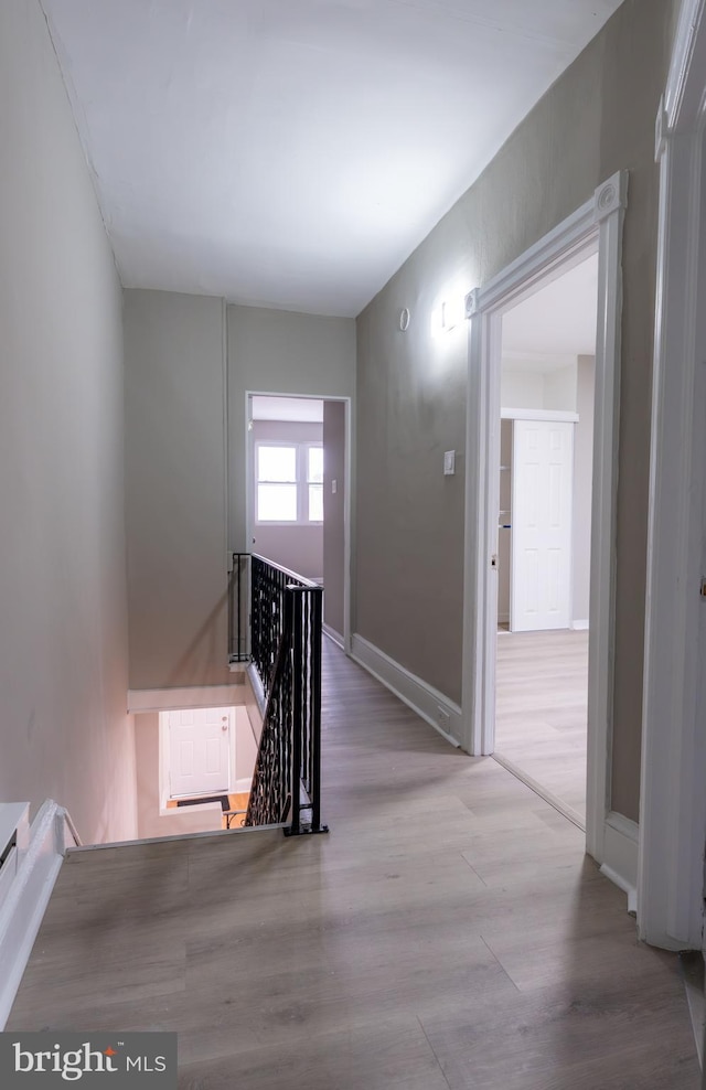 hallway with light hardwood / wood-style flooring