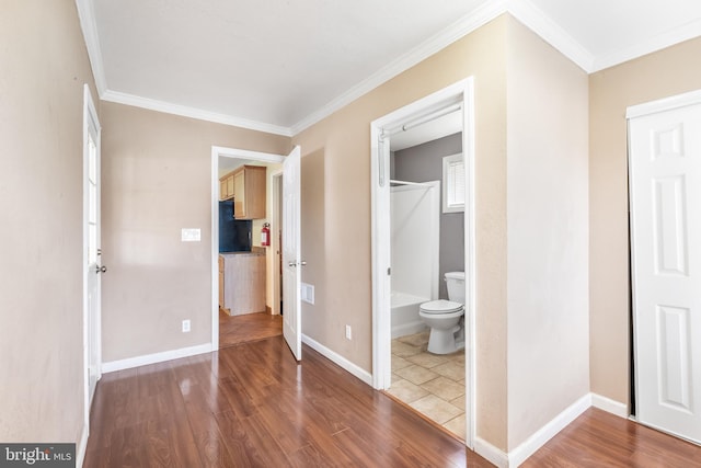 unfurnished bedroom featuring hardwood / wood-style flooring and crown molding