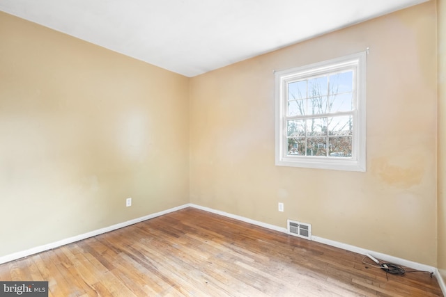 empty room with hardwood / wood-style floors