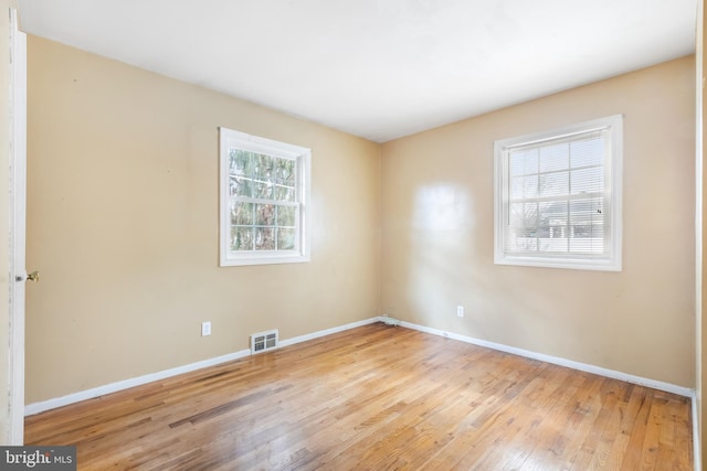 unfurnished room with light hardwood / wood-style flooring