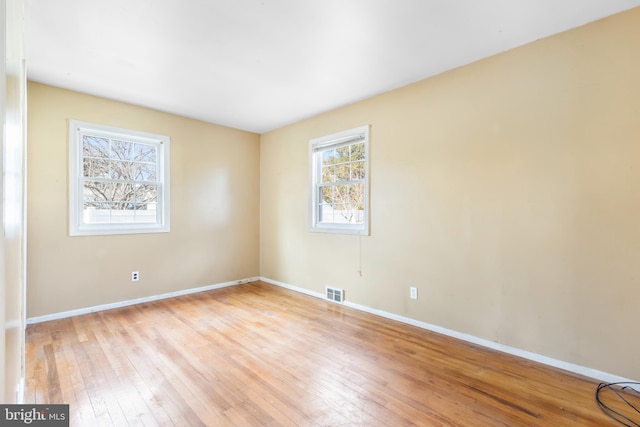 spare room featuring light hardwood / wood-style flooring