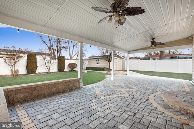 view of patio / terrace featuring ceiling fan and a storage unit