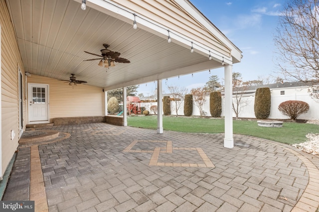 view of patio featuring a playground and ceiling fan