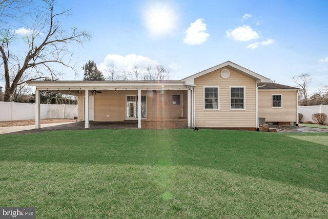 rear view of property featuring a yard and a carport