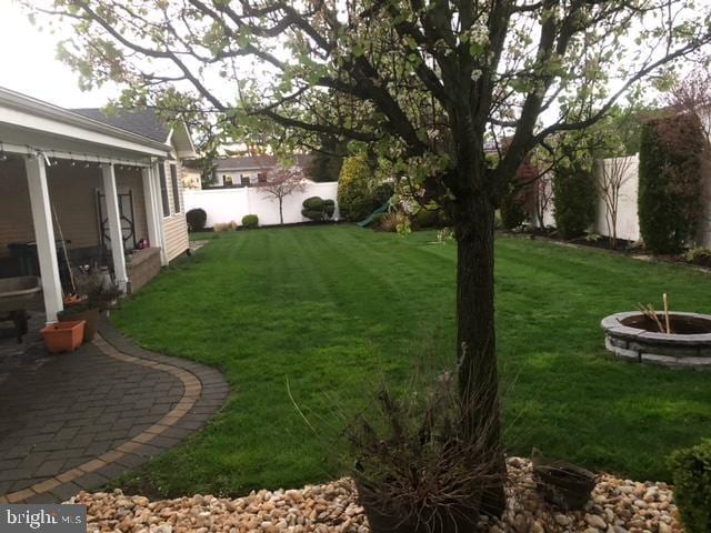 view of yard with an outdoor fire pit