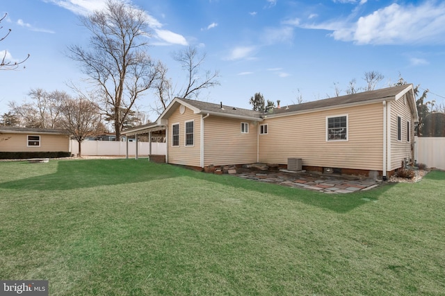 rear view of house featuring a lawn