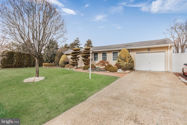 ranch-style house featuring a garage and a front yard