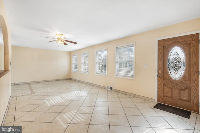 foyer featuring light tile patterned flooring and ceiling fan