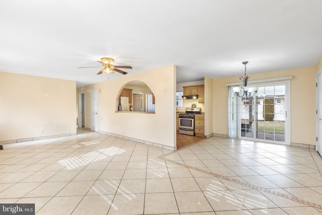 unfurnished living room featuring light tile patterned flooring and ceiling fan with notable chandelier