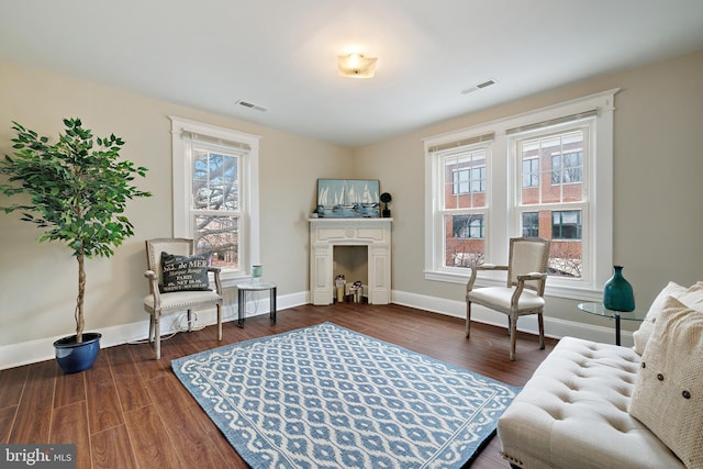 living area with dark wood-type flooring and plenty of natural light