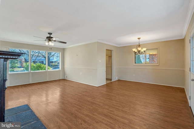 unfurnished room featuring ceiling fan with notable chandelier, crown molding, baseboards, and wood finished floors