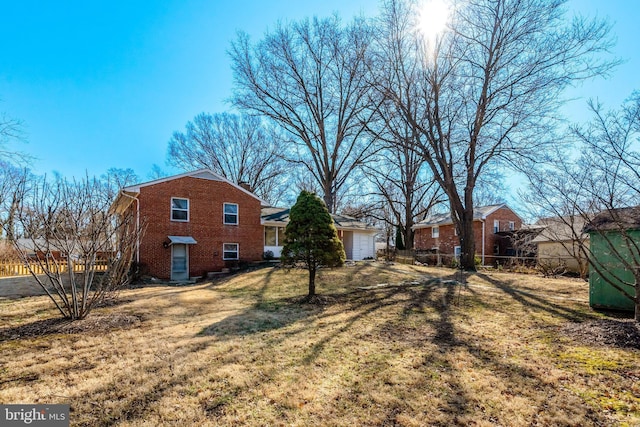 view of yard featuring a garage and fence