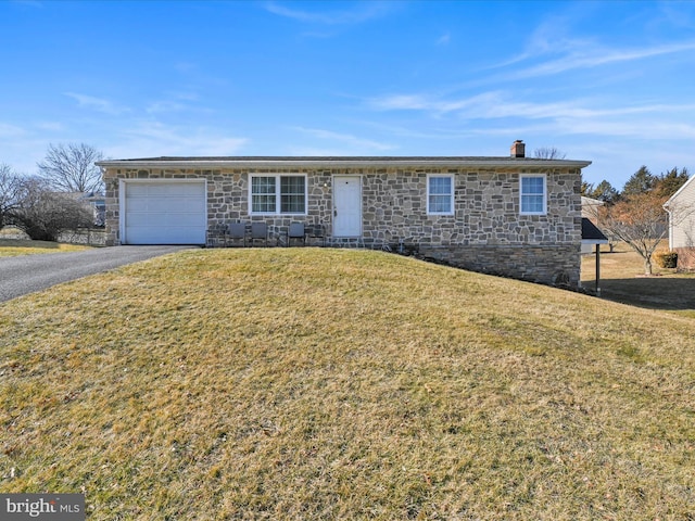 ranch-style house with an attached garage, driveway, a chimney, and a front yard