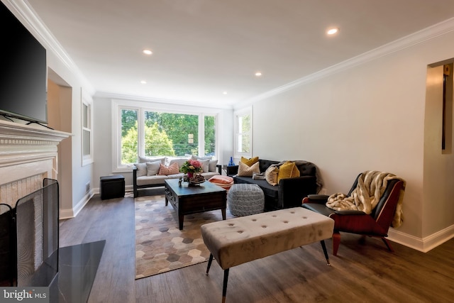 living room with a high end fireplace, ornamental molding, and dark hardwood / wood-style floors