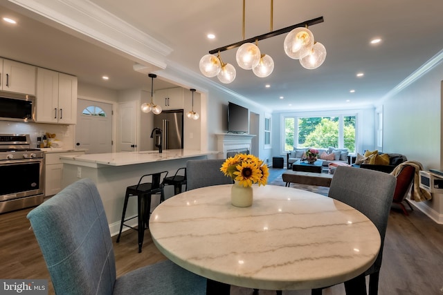 dining room with dark wood-type flooring and ornamental molding