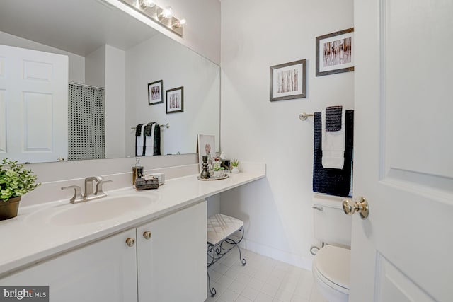 bathroom with vanity, tile patterned floors, and toilet