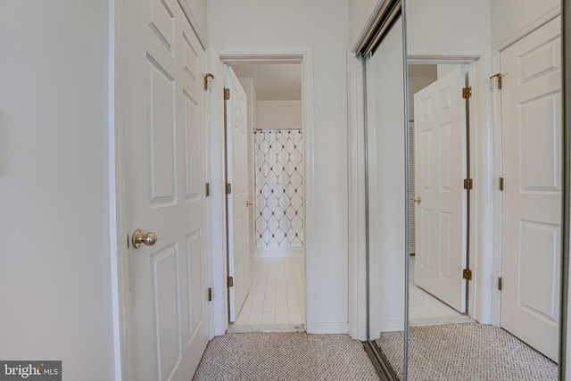 corridor with light tile patterned floors