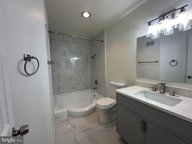 full bathroom with vanity, tiled shower / bath combo, and toilet