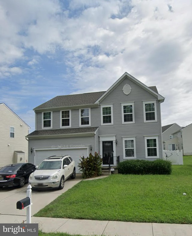 view of front of house with a garage and a front lawn