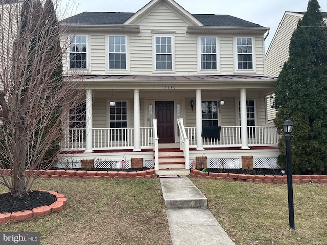 view of front of home with a front lawn and a porch