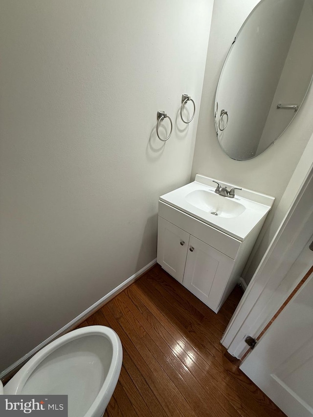 bathroom with hardwood / wood-style flooring and vanity