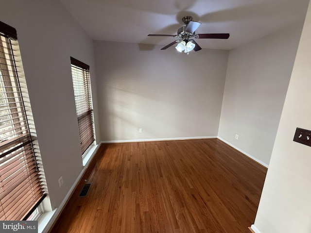 unfurnished room featuring ceiling fan and dark hardwood / wood-style floors