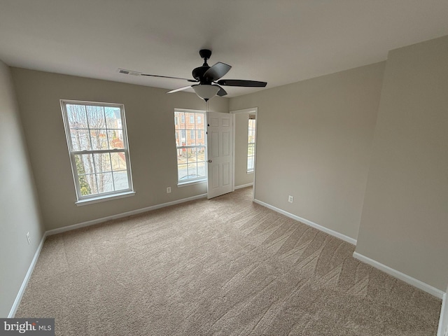 spare room with light carpet and ceiling fan