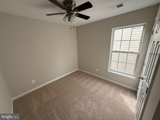 unfurnished room with ceiling fan and carpet