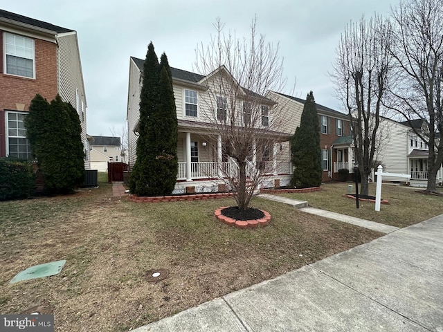 view of property with a porch, cooling unit, and a front lawn