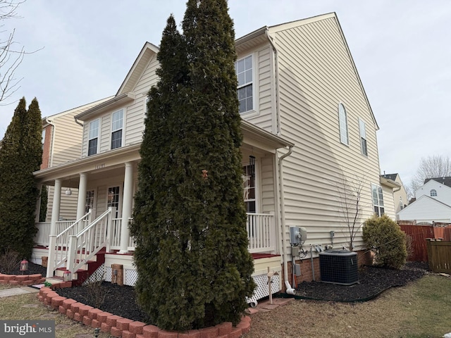 view of front facade featuring central air condition unit and a porch