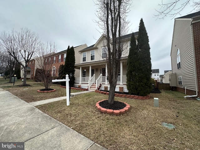 view of front of home with covered porch and a front yard