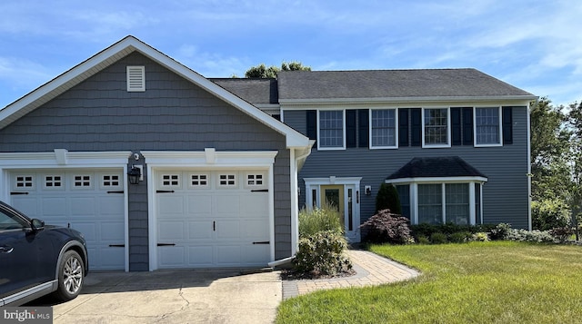 view of front facade with a garage, concrete driveway, and a front lawn