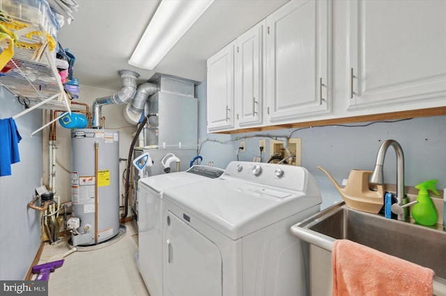 washroom with independent washer and dryer, gas water heater, a sink, and cabinet space