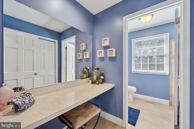 bathroom featuring toilet, tile patterned flooring, visible vents, and baseboards