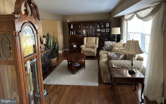 living area featuring dark wood-type flooring and visible vents