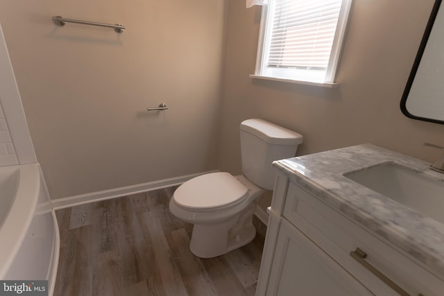 bathroom featuring hardwood / wood-style flooring, vanity, and toilet