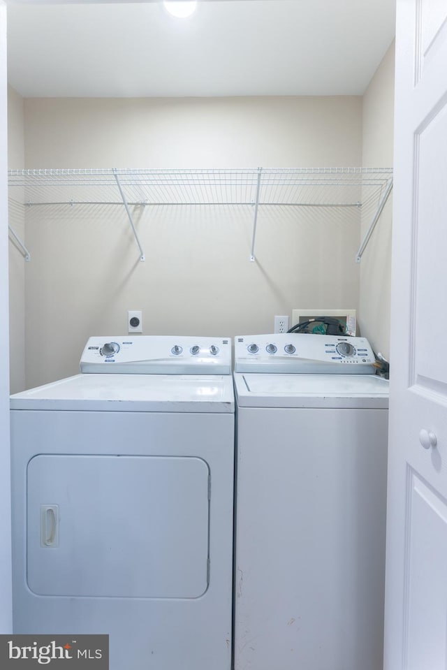 clothes washing area featuring separate washer and dryer