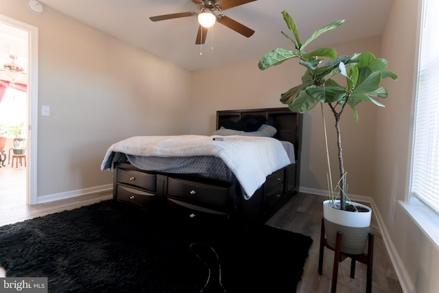 bedroom with ceiling fan and dark hardwood / wood-style floors