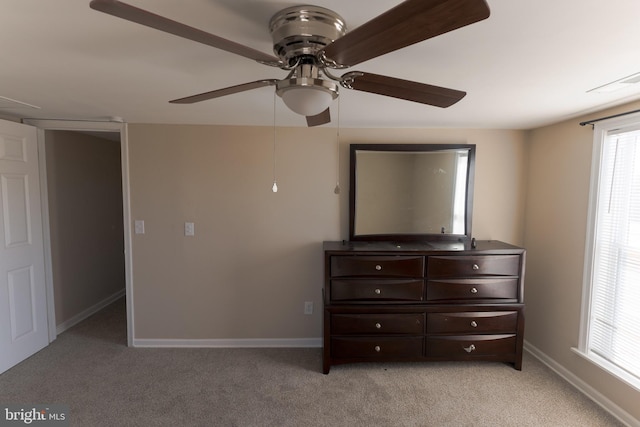 unfurnished bedroom with light colored carpet and ceiling fan