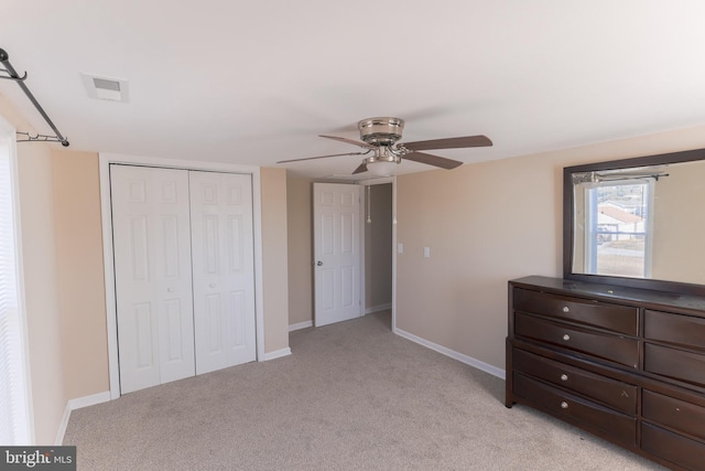 bedroom with light colored carpet, a closet, and ceiling fan