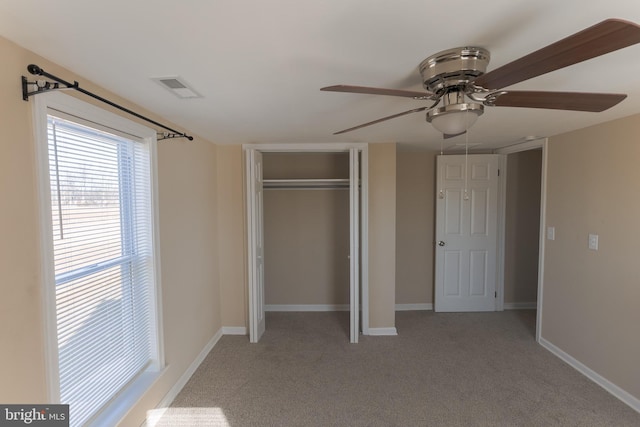 unfurnished bedroom with a closet, ceiling fan, and carpet flooring