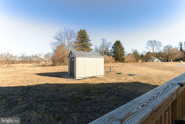 view of yard with a storage unit and a rural view