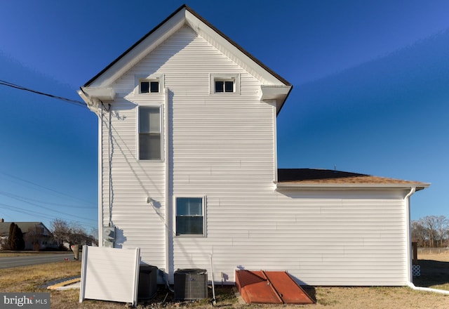 rear view of house with central AC unit