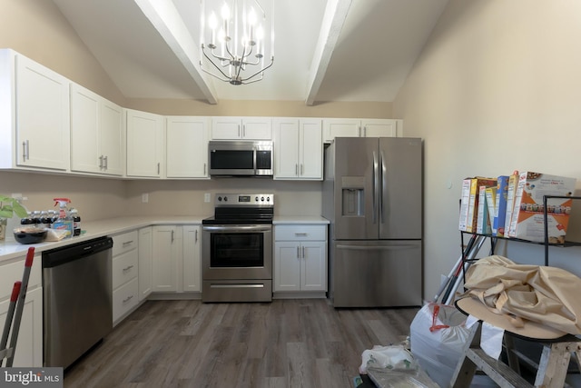 kitchen featuring vaulted ceiling with beams, appliances with stainless steel finishes, dark hardwood / wood-style floors, a notable chandelier, and white cabinets