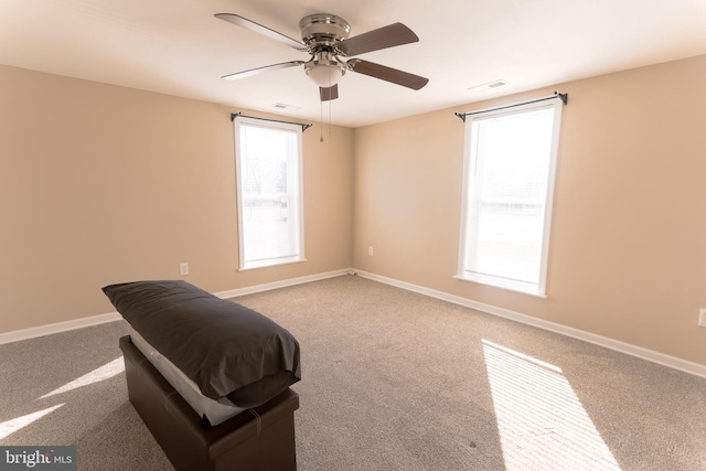 interior space with light carpet and ceiling fan