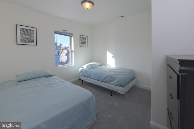 bedroom featuring dark colored carpet