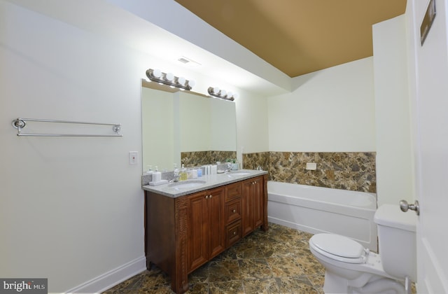 bathroom with vanity, a bath, and toilet