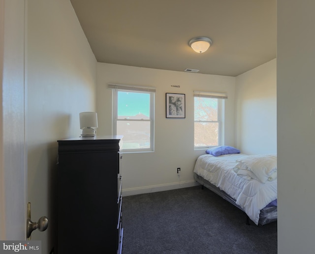 bedroom with dark colored carpet