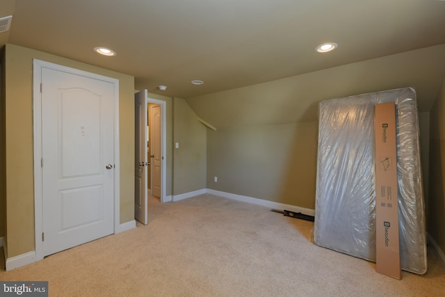 additional living space with vaulted ceiling and light colored carpet