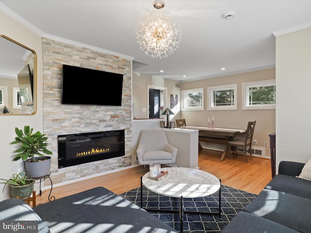 living room featuring ornamental molding, a fireplace, and hardwood / wood-style floors